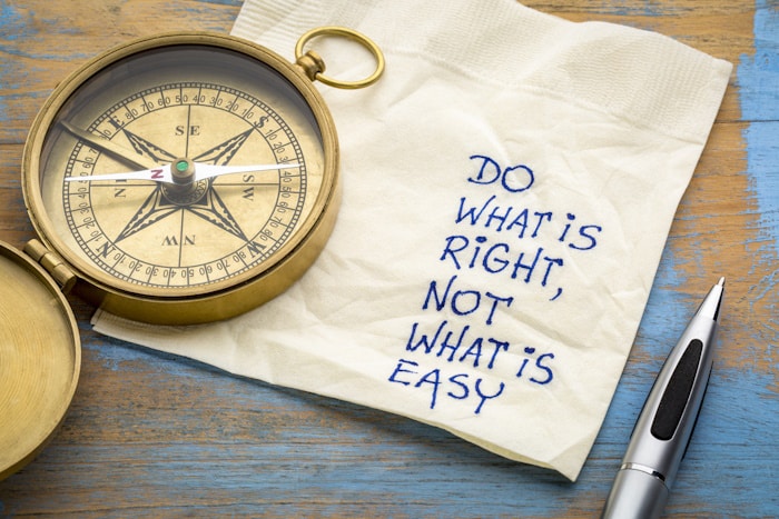 Do what is right, not what easy Do what is right, not what is easy advice or reminder - handwriting on a napkin with an antique brass compass