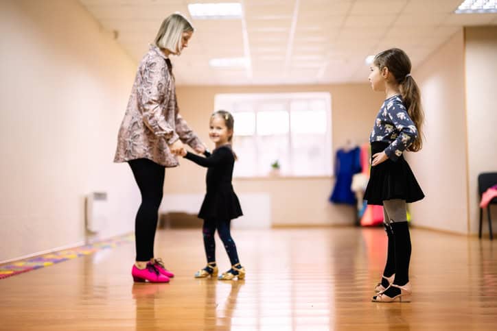 dance teacher with students in studio